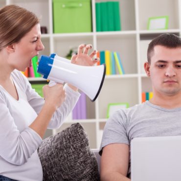 wife yelling at husband with lap top