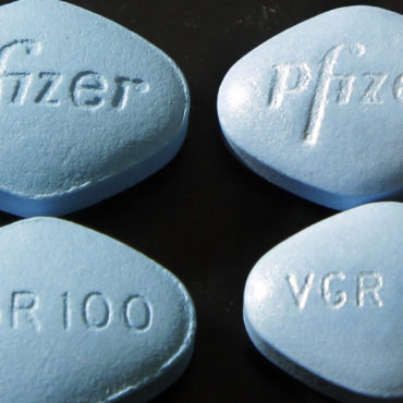FILE - In this Friday, March 2, 2012, file photo, counterfeit Viagra pills, top and bottom left, are displayed alongside real ones, top and bottom right, in a lab at Pfizer in Groton, Conn. In a first for the drug industry, Pfizer Inc. told The Associated Press on May 6, 2013, that it will sell erectile dysfunction pill Viagra directly to patients on its website. (AP Photo/Elise Amendola, File)