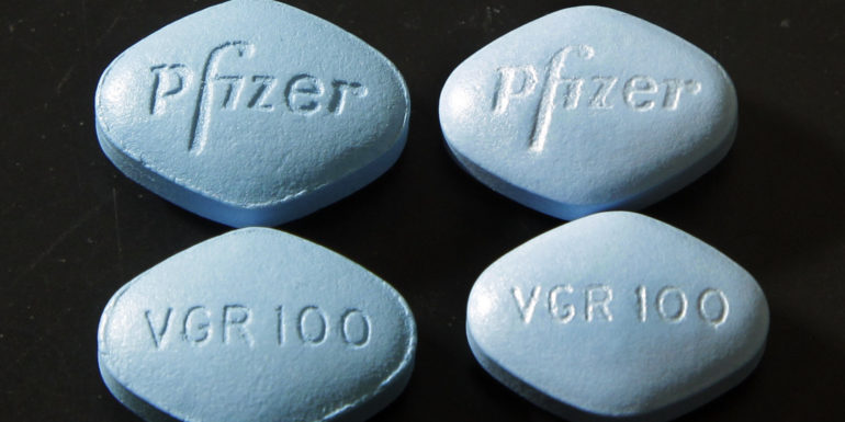FILE - In this Friday, March 2, 2012, file photo, counterfeit Viagra pills, top and bottom left, are displayed alongside real ones, top and bottom right, in a lab at Pfizer in Groton, Conn. In a first for the drug industry, Pfizer Inc. told The Associated Press on May 6, 2013, that it will sell erectile dysfunction pill Viagra directly to patients on its website. (AP Photo/Elise Amendola, File)
